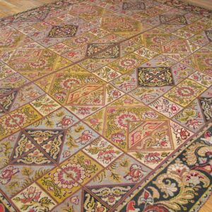 Close-up of a colorful, patchwork-style rug with geometric and floral motifs, by Rugs On Net