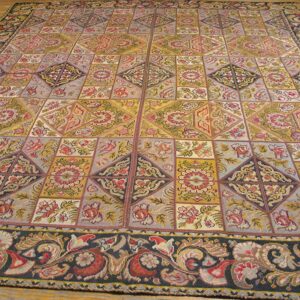 A large, colorful tapestry rug with a geometric patchwork design featuring floral motifs, by Rugs On Net. by Rugs On Net