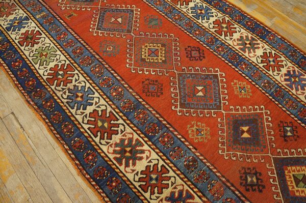 Close-up of a vibrant red runner rug with geometric medallions and blue borders, by rugs on net