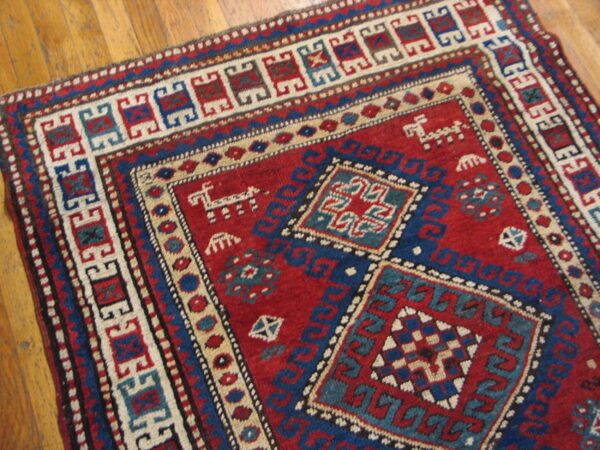Close-up of a red and blue geometric rug pattern by rugs on net