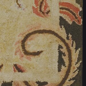 Close-up texture of a traditional rug with cream, red, and dark brown swirls by Rugs On Net