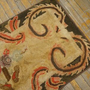 Close-up of a hooked rug with abstract floral and scroll patterns in earth tones, by Rugs On Net. by Rugs On Net