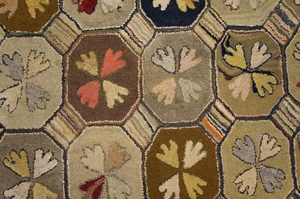 Colorful hexagonal patterned hooked rug