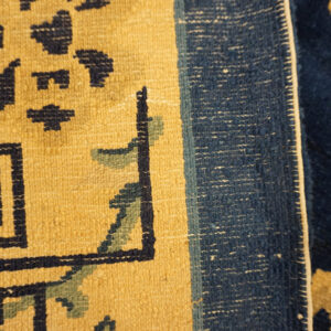 Intricate blue Chinese carpet design.