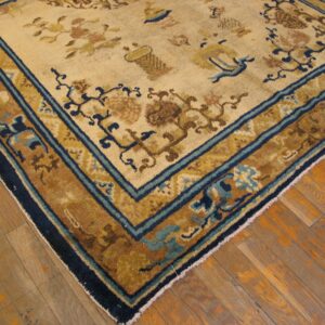 Close-up corner view of a beige and gold rug with blue accents by Rugs On Net. by Rugs On Net