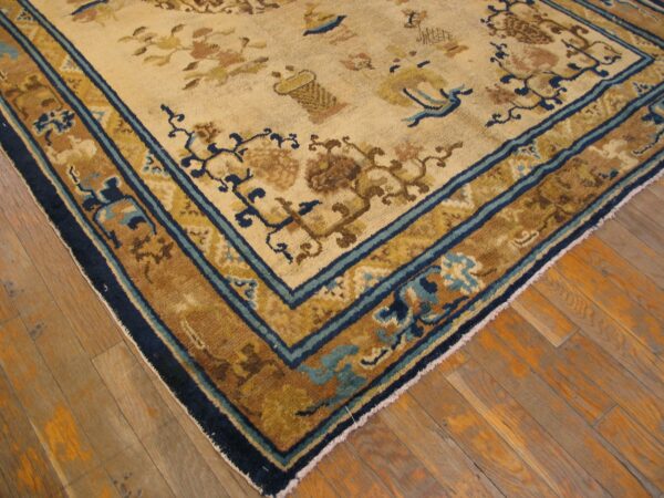 Close-up corner view of a beige and gold rug with blue accents by rugs on net. By rugs on net