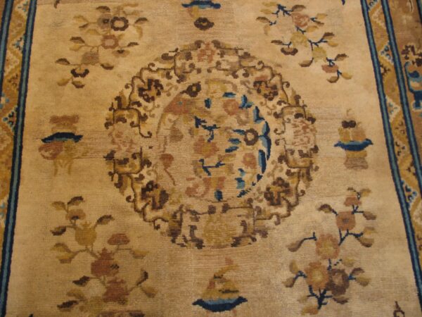 Close-up of a beige and brown floral pattern on an antique chinese rug by rugs on net. By rugs on net