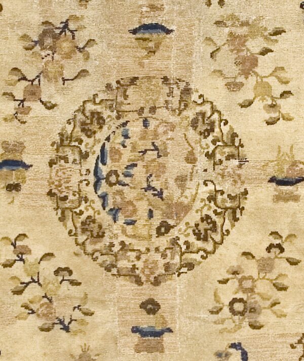 Close-up of a beige rug with faded brown and blue medallion details, by rugs on net