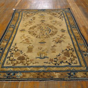 A vintage Chinese rug with a beige field and blue/brown accents, by Rugs On Net