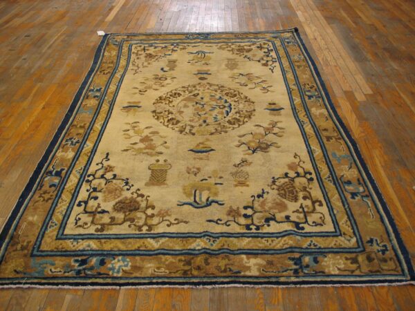 A vintage chinese rug with a beige field and blue/brown accents, by rugs on net
