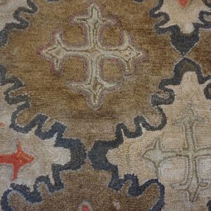 Close-up of a brown and beige rug with repeating stylized cross motifs by Rugs On Net