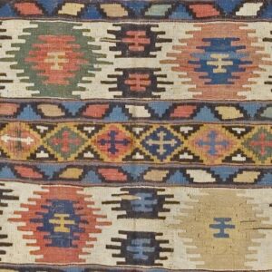 Close-up of a vibrant kilim rug featuring geometric motifs in red, blue, green, and cream by Rugs On Net. by Rugs On Net