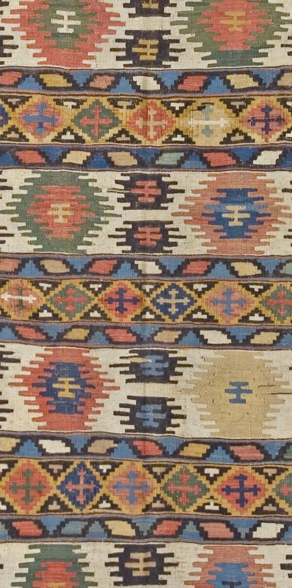 Close-up of a vibrant kilim rug featuring geometric motifs in red, blue, green, and cream by rugs on net. By rugs on net