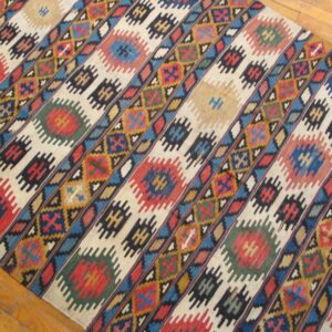Close-up view of a colorful kilim rug with diagonal stripes and geometric motifs, by Rugs On Net