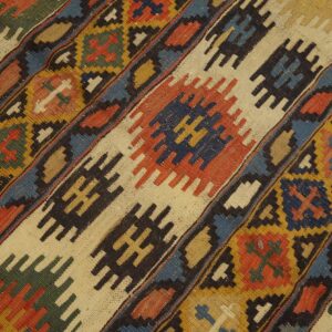 Close-up of diagonal geometric patterns in a colorful kilim rug by Rugs On Net. by Rugs On Net