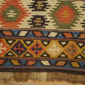 Close-up of a vibrant Kilim rug with geometric motifs and tassels, by Rugs On Net