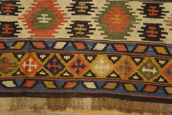 Close-up of a vibrant kilim rug with geometric motifs and tassels, by rugs on net