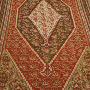 Kilim rug with geometric patterns in red, brown, and cream colors by Rugs On Net
