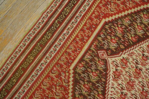 Close-up of the vibrant red and brown patterns on the kilim rug by rugs on net. By rugs on net