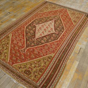 A vibrant red and green kilim rug with geometric patterns, displayed on a rustic wooden floor, by Rugs On Net. by Rugs On Net