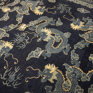 Dark blue dragon-patterned rug corner
