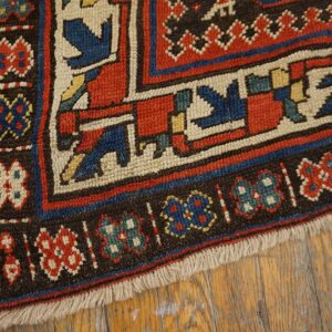 Close-up of the border of a colorful antique rug with geometric motifs by Rugs On Net. by Rugs On Net