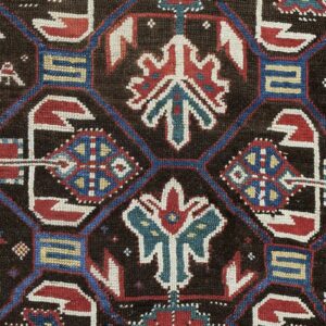 Close-up of dark brown field with geometric medallions in red, blue, and white from the 'Antique Kazak Rug' by Rugs On Net. by Rugs On Net