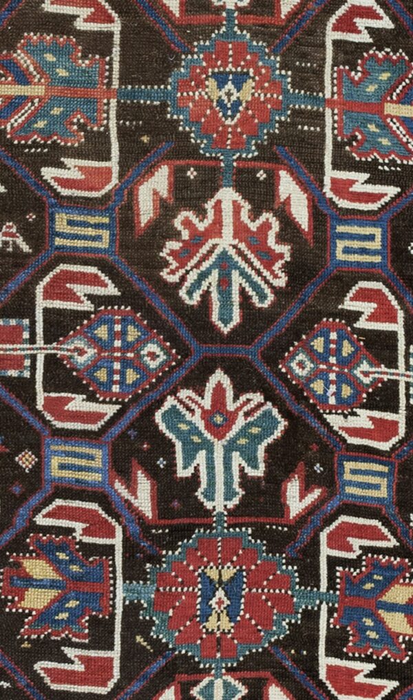 Close-up of dark brown field with geometric medallions in red, blue, and white from the 'antique kazak rug' by rugs on net. By rugs on net