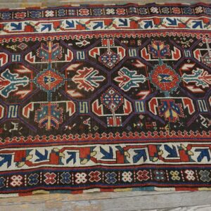 Dark field antique Caucasian rug with geometric motifs by Rugs On Net