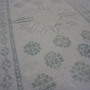 Faded patterned vintage Indian carpet