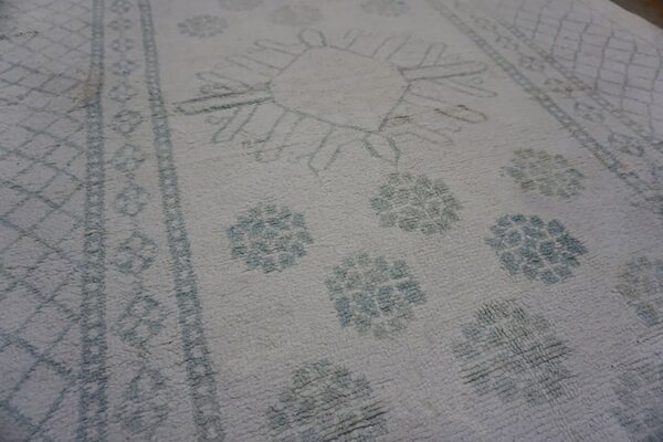 Faded patterned vintage indian carpet