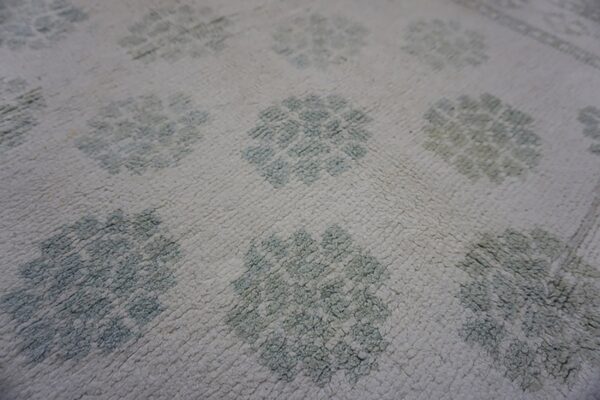 Faded floral pattern on cotton carpet