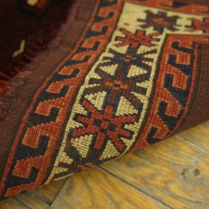 Close-up of the edge and border pattern of a deep red and beige tribal rug by Rugs On Net. by Rugs On Net