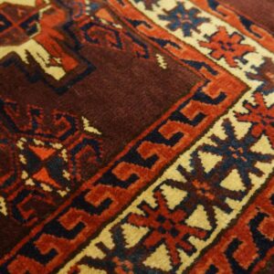 Close-up of the intricate border design on a deep red and brown rug by Rugs On Net. by Rugs On Net