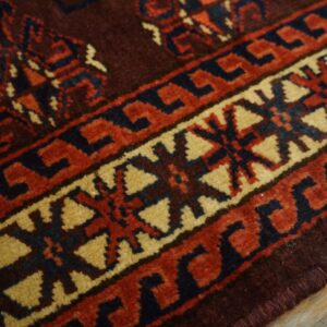 Close-up of the intricate border design on a deep red and brown rug by Rugs On Net. by Rugs On Net