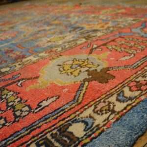 Close-up texture of a vibrant antique rug with red and blue tones, by Rugs On Net