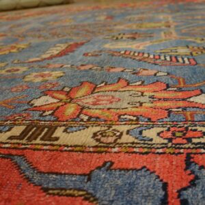 Close-up texture of a blue and red patterned rug by Rugs On Net