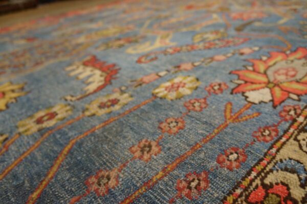 Close-up of a blue field rug with floral motifs by rugs on net. By rugs on net