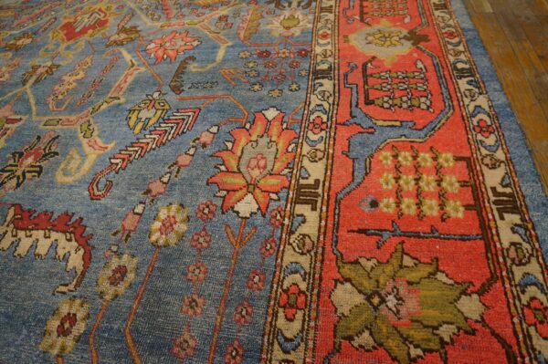 Close-up of a blue field rug with red border details, featuring floral and geometric motifs, by rugs on net