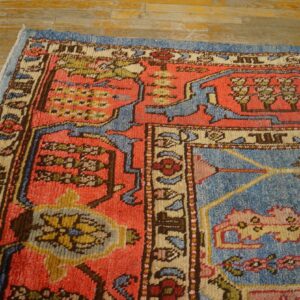 Corner detail of a vibrant, antique-style rug with coral and blue fields, by Rugs On Net. by Rugs On Net