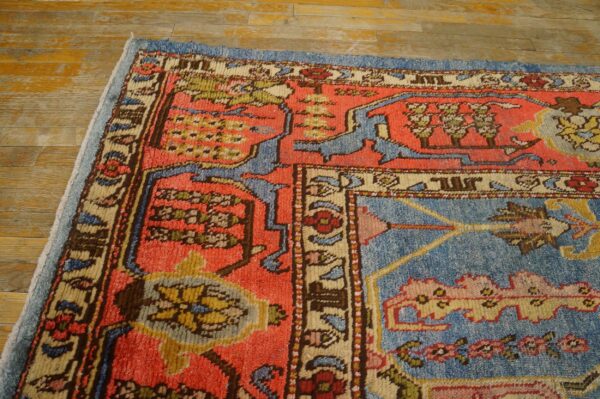 Corner detail of a vibrant, antique-style rug with coral and blue fields, by rugs on net. By rugs on net
