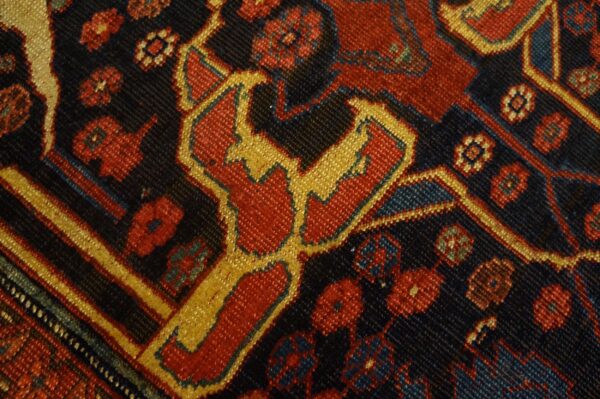 Close-up of a detailed, dark field rug pattern featuring red and gold geometric motifs by rugs on net