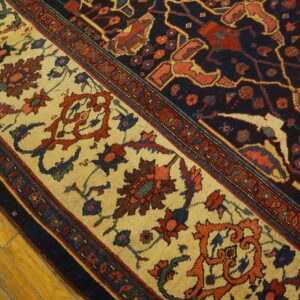 Close-up of the ornate border of a Persian rug featuring cream, red, and navy motifs by Rugs On Net. by Rugs On Net