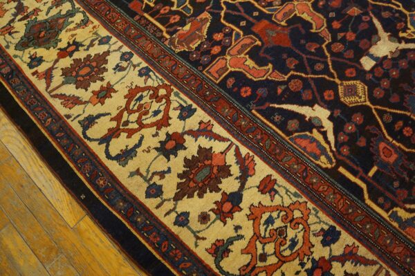 Close-up of the ornate border of a persian rug featuring cream, red, and navy motifs by rugs on net. By rugs on net