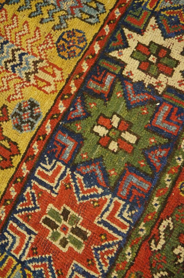 Close-up of colorful geometric patterns on a tribal rug by rugs on net. By rugs on net
