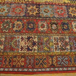 Close-up of colorful, geometric patterns on an antique rug by Rugs On Net. by Rugs On Net