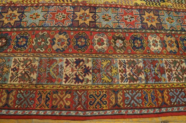 Close-up of colorful, geometric patterns on an antique rug by rugs on net. By rugs on net