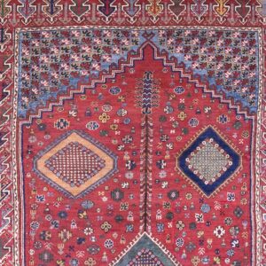 Close-up of a prayer rug with a red field and geometric motifs by Rugs On Net