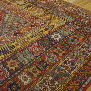 Close-up of a richly patterned, multicolored antique rug with geometric and floral motifs, by Rugs On Net. by Rugs On Net