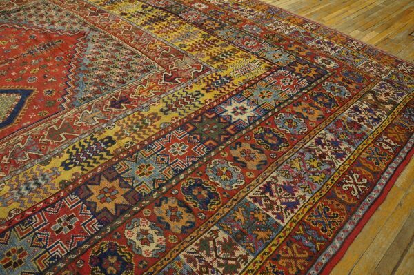 Close-up of a richly patterned, multicolored antique rug with geometric and floral motifs, by rugs on net. By rugs on net